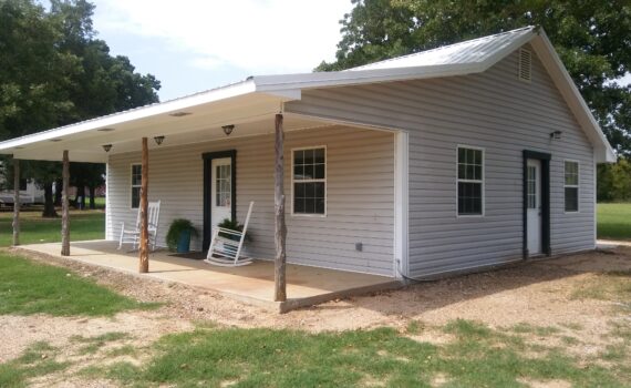 White house with covered porch and rocking chairs