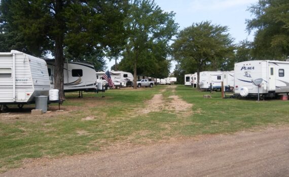 RVs parked along grassy campground road