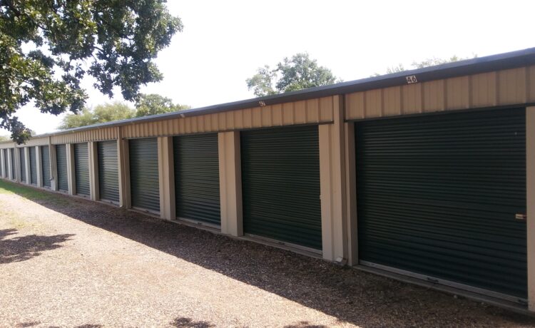 Row of green roll-up storage unit doors